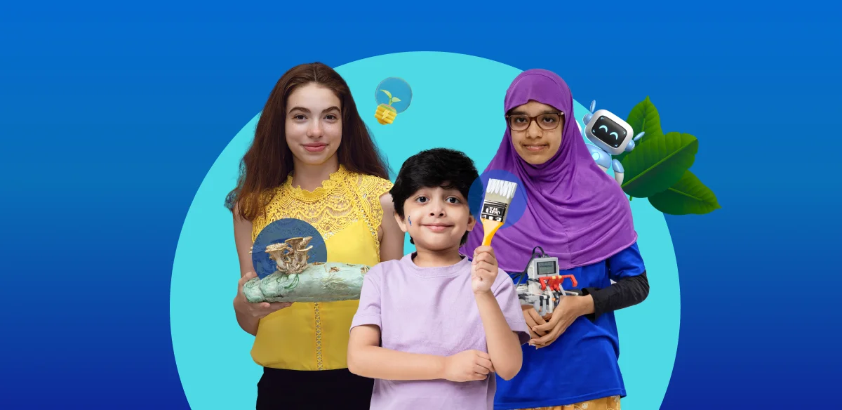 A girl holding a art project, a boy with a brush and a girl with a small robot